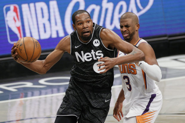 Kevin Durant #7 of the Brooklyn Nets drives to the basket as Chris Paul #3 of the Phoenix Suns defends during the second half at Barclays Center on April 25, 2021 in the Brooklyn borough of New York City. NOTE TO USER: User expressly acknowledges and agrees that, by downloading and or using this photograph, User is consenting to the terms and conditions of the Getty Images License Agreement. Sarah Stier/Getty Images/AFP (Photo by Sarah Stier / GETTY IMAGES NORTH AMERICA / Getty Images via AFP)