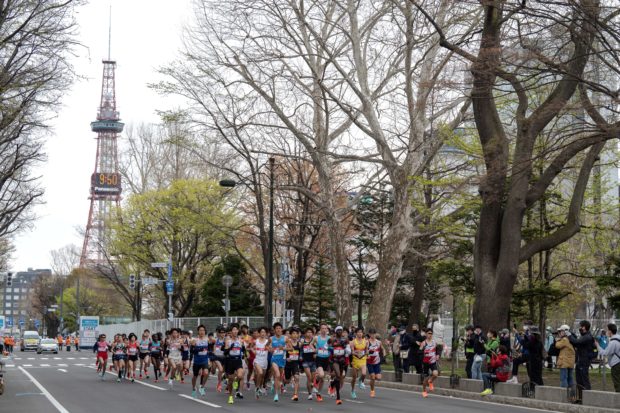 Athletes compete at the half-marathon race which doubles as a test event for the 2020 Tokyo Olympics, in Sapporo on May 5, 2021. (Photo by Charly TRIBALLEAU / POOL / AFP)