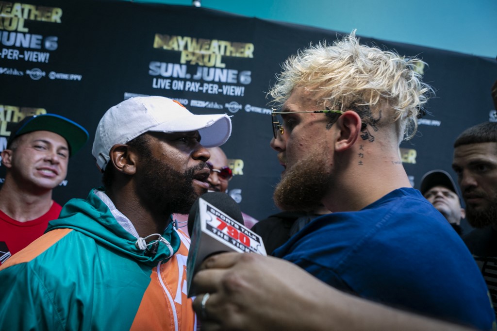 Floyd Mayweather (L) and Jake Paul pose during a press conference 