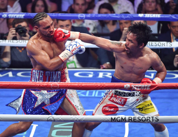Manny Pacquiao (R) throws a right at Keith Thurman in the sixth round of their WBA welterweight title fight at MGM Grand Garden Arena on July 20, 2019 in Las Vegas, Nevada. Pacquiao won in a split decision.   Ethan Miller/Getty Images/AFP (Photo by Ethan Miller / GETTY IMAGES NORTH AMERICA / Getty Images via AFP)