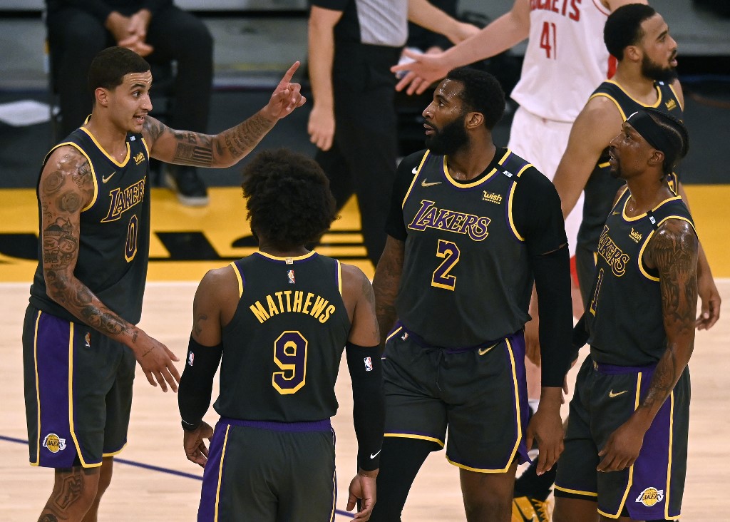 LOS ANGELES, CALIFORNIA - MAY 12: Kyle Kuzma #0 of the Los Angeles Lakers talks to Wesley Matthews #9 Andre Drummond #2 and Kentavious Caldwell-Pope