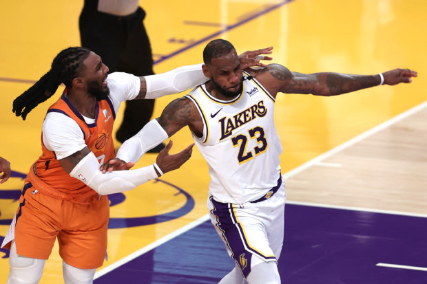 Jae Crowder #99 of the Phoenix Suns fouls LeBron James #23 of the Los Angeles Lakers during the second half of Game Four of the Western Conference first-round playoff series at Staples Center on May 30, 2021 in Los Angeles, California. NOTE TO USER: User expressly acknowledges and agrees that, by downloading and or using this photograph, User is consenting to the terms and conditions of the Getty Images License Agreement. Sean M. Haffey/Getty Images/AFP (Photo by Sean M. Haffey / GETTY IMAGES NORTH AMERICA / Getty Images via AFP)