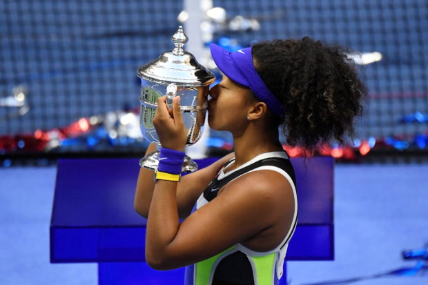 Flushing Meadows, New York, USA; Naomi Osaka of Japan celebrates with the championship trophy after her match against Victoria Azarenka of Belarus (not pictured) in the women's singles final on day thirteen of the 2020 U.S. Open tennis tournament at USTA Billie Jean King National Tennis Center. Mandatory Credit: Danielle Parhizkaran-USA TODAY Sports/File Photo