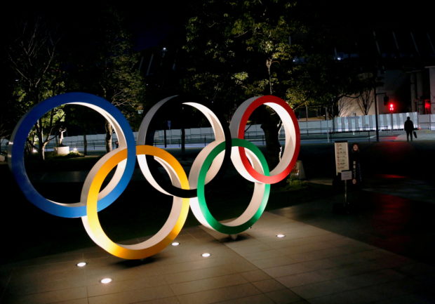 The Olympic rings are illuminated in front of the National Stadium in Tokyo, Japan January 22, 2021. REUTERS/Kim Kyung-Hoon/File Photo
