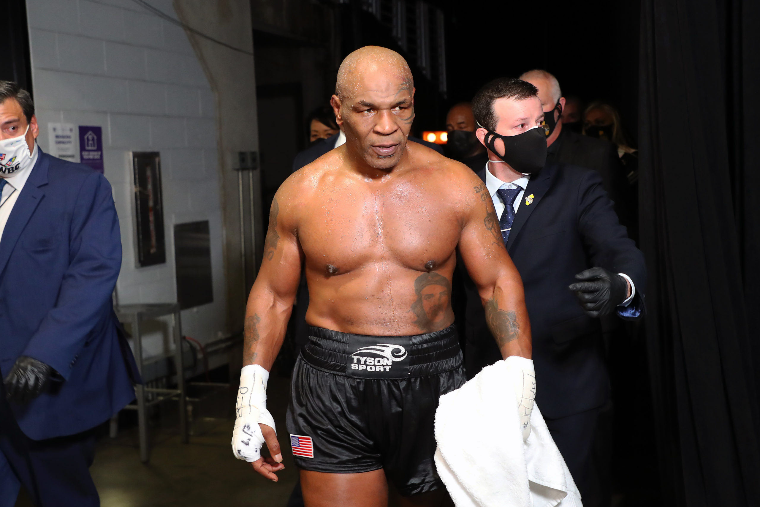 Mike Tyson (black trunks) exits the ring after his split draw against Roy Jones, Jr. (white trunks) during a heavyweight exhibition boxing bout for the WBC Frontline Belt at the Staples Center. Mandatory Credit: Joe Scarnici/Handout Photo via USA TODAY Sports