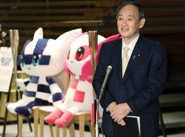 Japan's Prime Minister Yoshihide Suga speaks to members of the media at the prime minister's office in Tokyo on February 18, 2021, after former Olympic Minister Seiko Hashimoto became the new president of the Tokyo 2020 Olympics Organising Committee. (Photo by STR / JIJI PRESS / AFP)