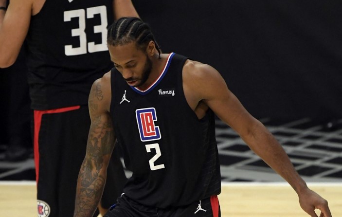 (FILES) In this file photo taken on June 14, 2021, Kawhi Leonard #2 of the Los Angeles Clippers holds his knee during the second half against the Utah Jazz in Game Four of the Western Conference second-round playoff series at Staples Center in Los Angeles, California.