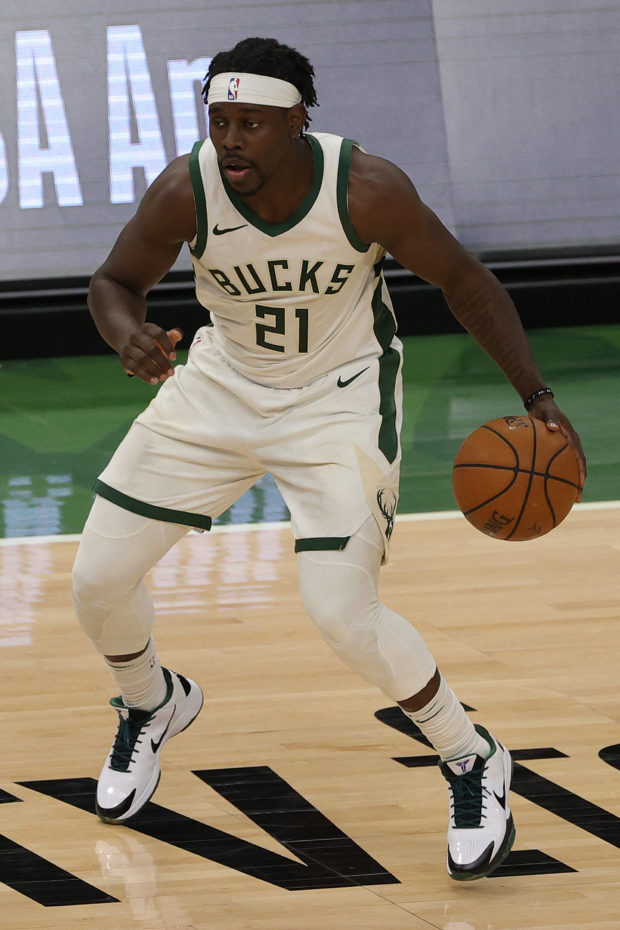 Jrue Holiday #21 of the Milwaukee Bucks handles the ball during a game against the Brooklyn Nets at Fiserv Forum on May 04, 2021 in Milwaukee, Wisconsin. NOTE TO USER: User expressly acknowledges and agrees that, by downloading and or using this photograph, User is consenting to the terms and conditions of the Getty Images License Agreement. Stacy Revere/Getty Images/AFP (Photo by Stacy Revere / GETTY IMAGES NORTH AMERICA / Getty Images via AFP)