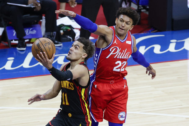 Trae Young #11 of the Atlanta Hawks shoots under Matisse Thybulle #22 of the Philadelphia 76ers during the fourth quarter during Game One of the Eastern Conference second round series at Wells Fargo Center on June 06, 2021 in Philadelphia, Pennsylvania. NOTE TO USER: User expressly acknowledges and agrees that, by downloading and or using this photograph, User is consenting to the terms and conditions of the Getty Images License Agreement. Tim Nwachukwu/Getty Images/AFP (Photo by Tim Nwachukwu / GETTY IMAGES NORTH AMERICA / Getty Images via AFP)