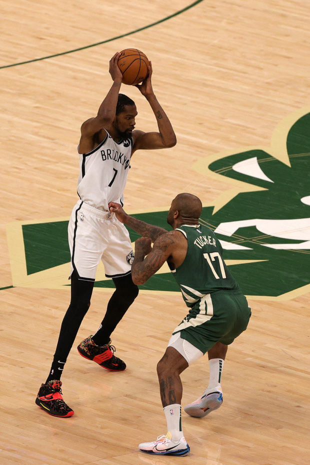 Kevin Durant #7 of the Brooklyn Nets is defended by P.J. Tucker #17 of the Milwaukee Bucks during the second half of Game Three of the Eastern Conference second round playoff series at the Fiserv Forum on June 10, 2021 in Milwaukee, Wisconsin. NOTE TO USER: User expressly acknowledges and agrees that, by downloading and or using this photograph, User is consenting to the terms and conditions of the Getty Images License Agreement.   Stacy Revere/Getty Images/AFP (Photo by Stacy Revere / GETTY IMAGES NORTH AMERICA / Getty Images via AFP)