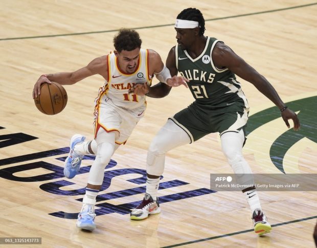  Trae Young #11 of the Atlanta Hawks drives against Jrue Holiday #21 of the Milwaukee Bucks during the second quarter in game one of the Eastern Conference Finals at Fiserv Forum on June 23, 2021 in Milwaukee, Wisconsin. Patrick McDermott/Getty Images/AFP (Photo by Patrick McDermott / GETTY IMAGES NORTH AMERICA / Getty Images via AFP)