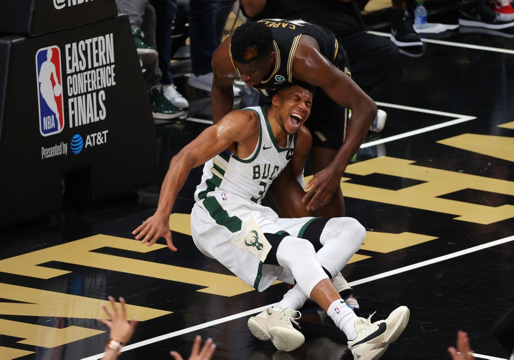 Giannis Antetokounmpo #34 of the Milwaukee Bucks is injured against Clint Capela #15 of the Atlanta Hawks 