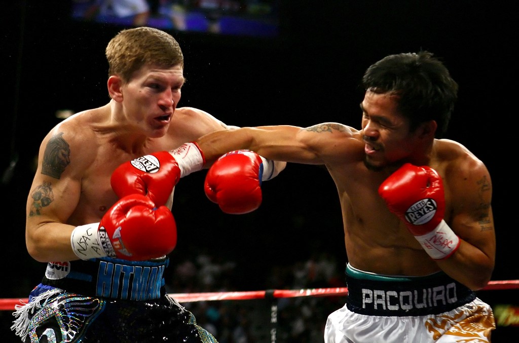 Manny Pacquiao of the Philippines throws a right to the face of Ricky Hatton of England 