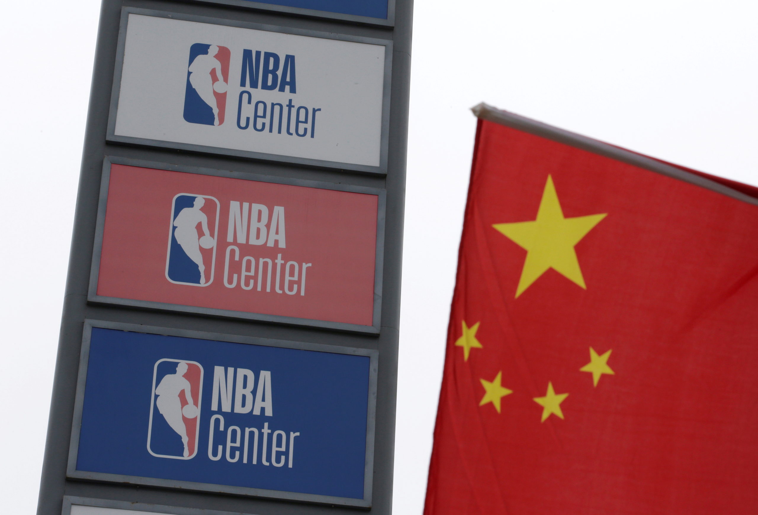NBA logos are seen next to a Chinese national flag outside a NBA-themed lifestyle complex