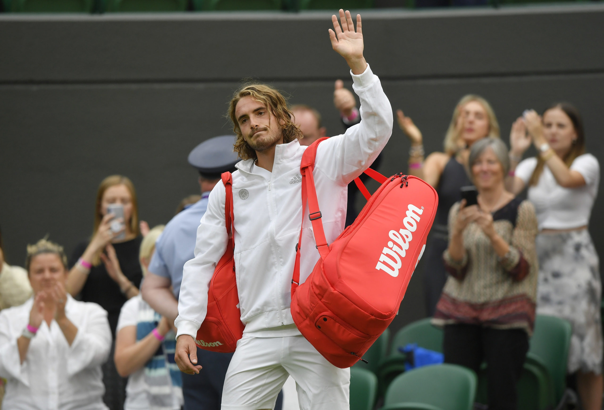 Greece's Stefanos Tsitsipas looks dejected as he waves after losing his first round match against Frances Tiafoe of the U.S. 