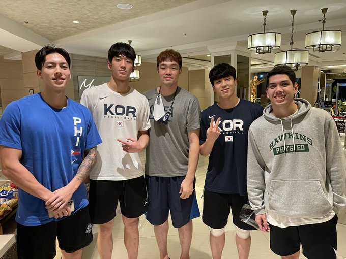 Gilas Pilipinas' Dwight Ramos (left) and Mike Nieto (right) with players of the Korean national team after the Fiba Asia Cup qualifiers