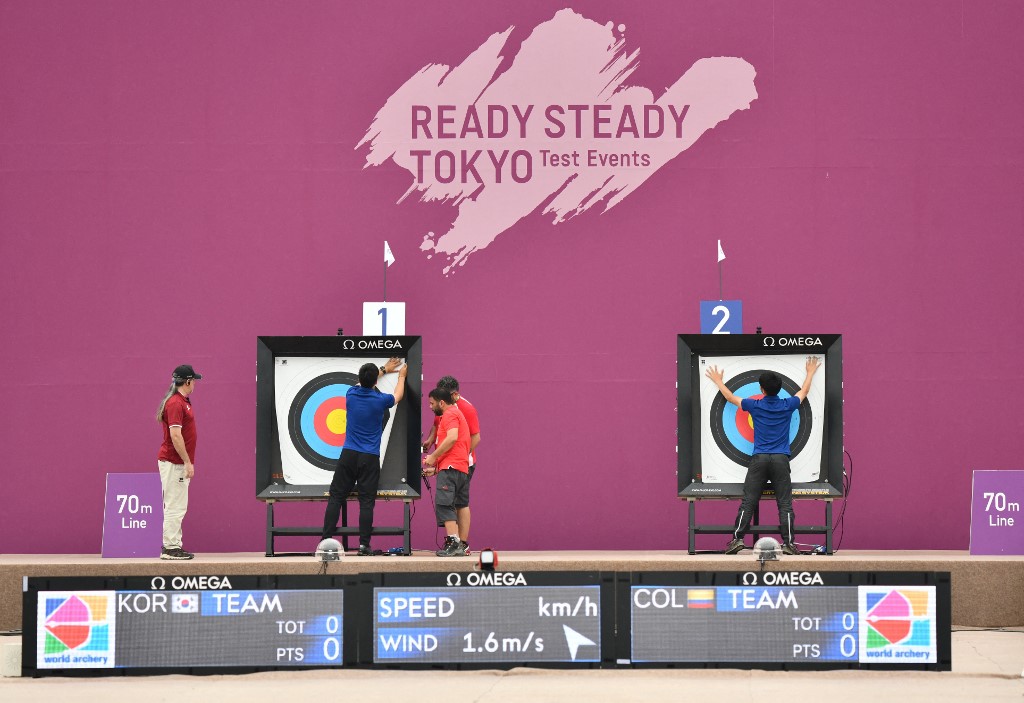 Competition officials change targets following a competition in the archery test event for Tokyo 2020 Olympic Games at Yumenoshima Park Archery Field in Tokyo on July 13, 2019.