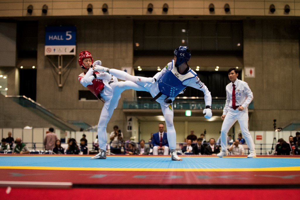 Brazil's Talisca Reis (blue) and China's Yuntao Wenren (red) fight in the women's under 49kg semi-final of the Ready Steady Tokyo taekwondo, a test event ahead of the Tokyo 2020 Olympic Games at Makuhari Messe International Confrence Hall A, venue for taekwondo and wrestling competitions at the Tokyo 2020 Olympic Games,