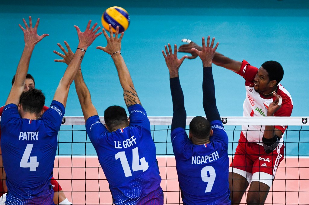 France's Jean Patry, Nicolas Le Goff and Earvin Ngapeth try to block Poland's Leon Venero Wilfredo during the third place match of the Men's 2019 CEV Volleyball European Championship between France and Poland