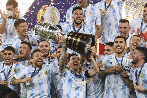 Argentina's Lionel Messi holds the trophy as he celebrates on the podium with teammates after winning the Conmebol 2021 Copa America football tournament final match against Brazil at Maracana Stadium in Rio de Janeiro, Brazil, on July 10, 2021. - Argentina won 1-0. 