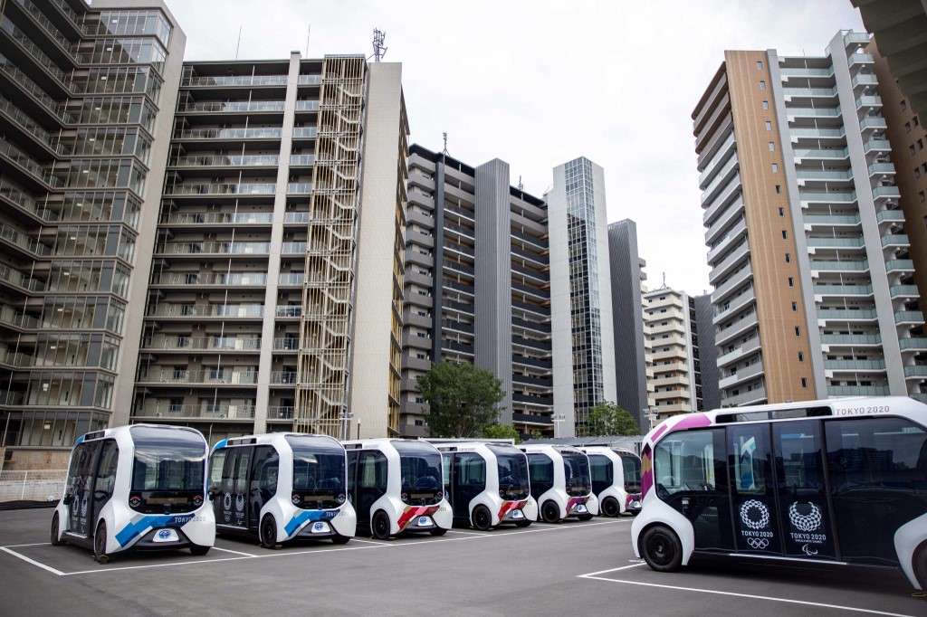 (FILES) In this file photo taken on June 20, 2021, autonomous electric vehicles, which will be used at the Olympic Village, are seen during a media tour of the Tokyo 2020 Olympic and Paralympic Village in Tokyo. - For athletes competing at the Tokyo Games, the Olympic Village will be almost all they see, with strict coronavirus rules preventing them from leaving the compound except to train and compete. 