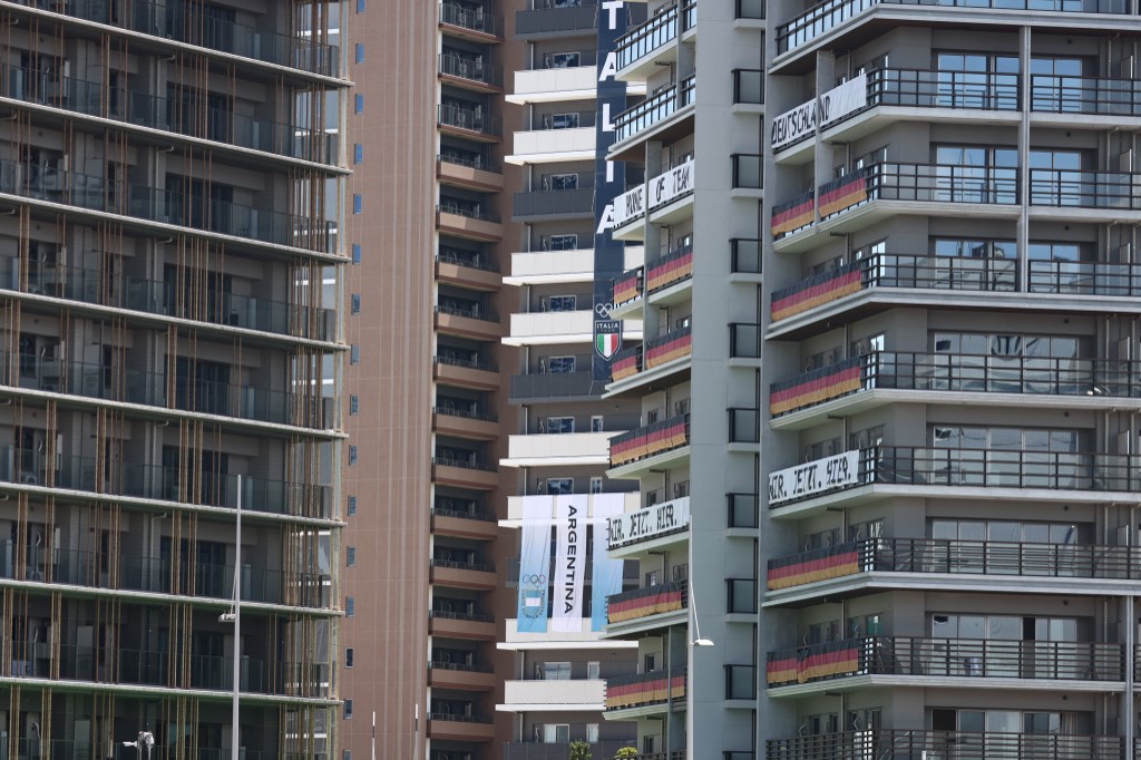 Flags and banners of Argentina, Germany and Italy are seen on the buildings of the Tokyo 2020 Olympic village in Tokyo on July 18, 2021,