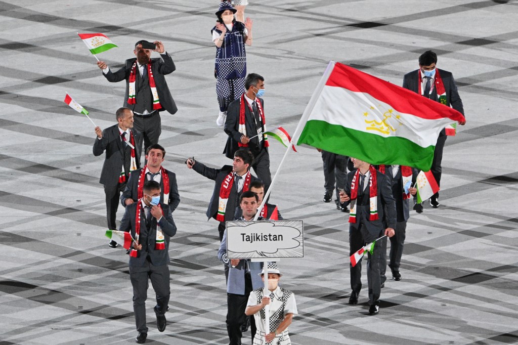 Tajikistan's flag bearer Temur Rakhimov leads the delegation during the opening ceremony of the Tokyo 2020 Olympic Games, at the Olympic Stadium, in Tokyo, on July 23, 2021