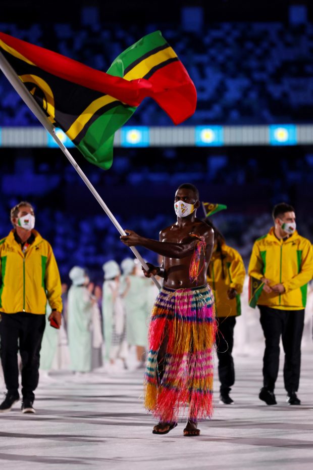 Vanuatu's flag bearer Riilio Rii parades during the opening ceremony of the Tokyo 2020 Olympic Games, at the Olympic Stadium, in Tokyo, on July 23, 2021. AFP