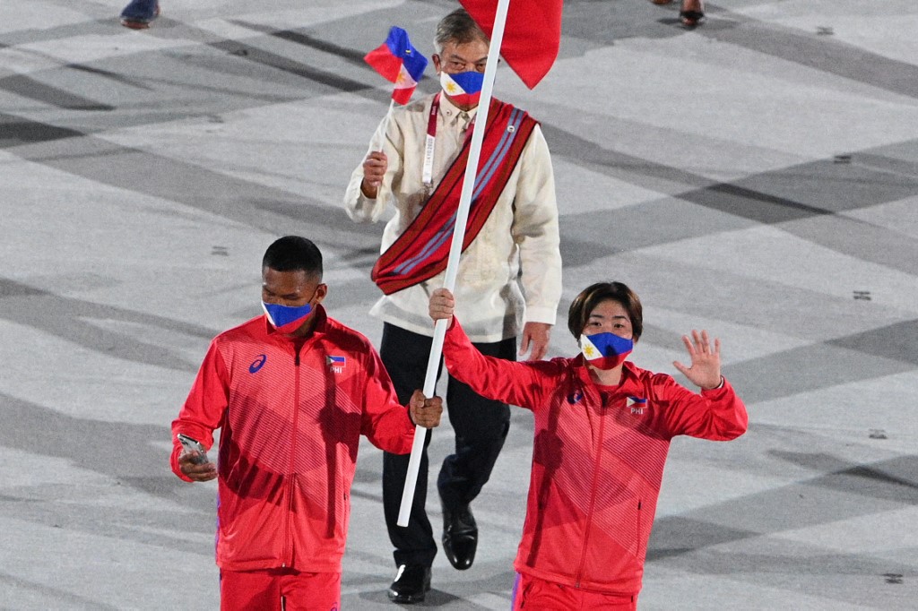 Philippines's flag bearer Kiyomi Watanabe and Philippines' flag bearer Eumir Marcial lead the delegation during the opening ceremony of the Tokyo 2020 Olympic Games, at the Olympic Stadium, in Tokyo, on July 23, 2021.