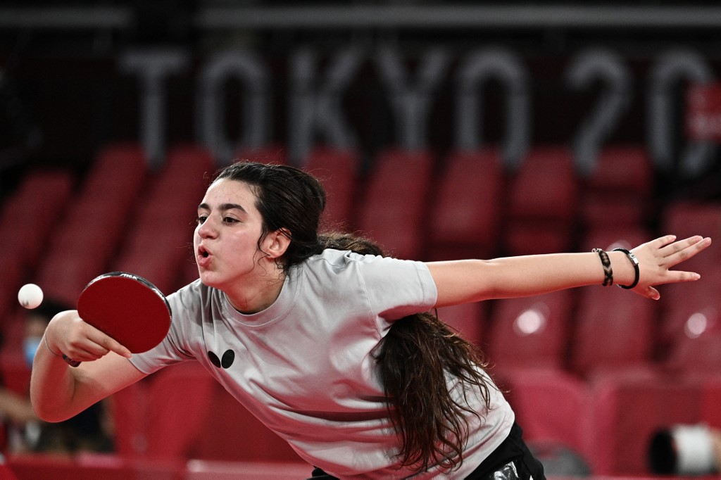 Syria's Hend Zaza hits a shot against Austria's Liu Jia during their women's singles preliminary round table tennis match at the Tokyo Metropolitan Gymnasium during the Tokyo 2020 Olympic Games in Tokyo on July 24, 2021. 