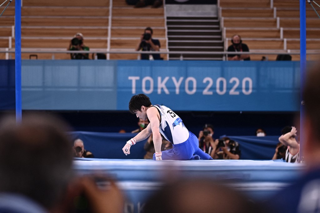 Japan's Kohei Uchimura reacts after competing in the horizontal bars event of the artistic gymnastics men's qualification during the Tokyo 2020 Olympic Games at the Ariake Gymnastics Centre in Tokyo on July 24, 2021. (Photo by Lionel BONAVENTURE / AFP)
