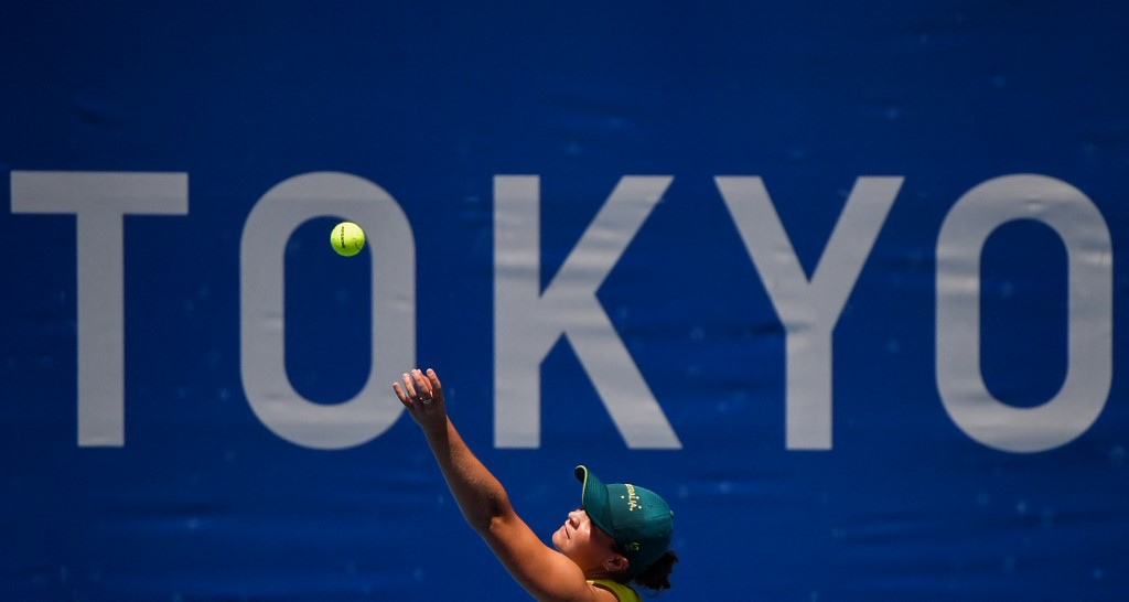 Australia's Ashleigh Barty serves to Spain's Sara Sorribes Tormo during their Tokyo 2020 Olympic Games women's singles first round tennis match at the Ariake Tennis Park in Tokyo on July 25, 2021.