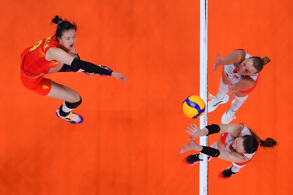 China's Zhang Changning (L) spikes the ball in the women's preliminary round pool B volleyball match between China and Turkey during the Tokyo 2020 Olympic Games at Ariake Arena in Tokyo on July 25, 2021. 