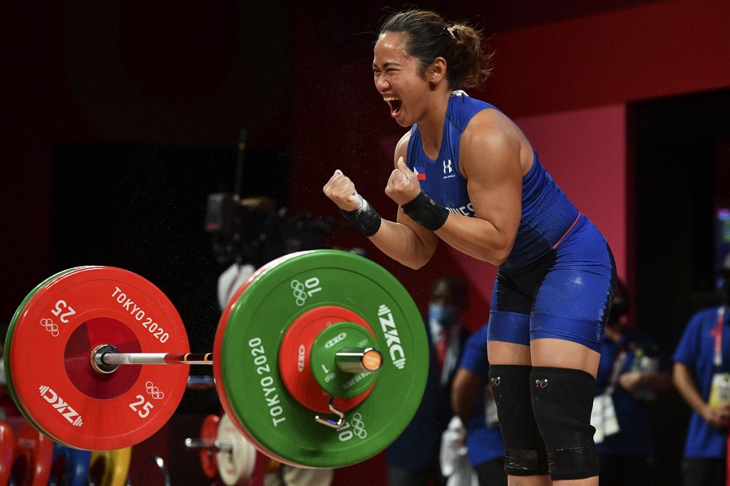 Philippines' Hidilyn Diaz reacts while competing in the women's 55kg weightlifting competition during the Tokyo 2020 Olympic Games at the Tokyo International Forum in Tokyo on July 26, 2021.