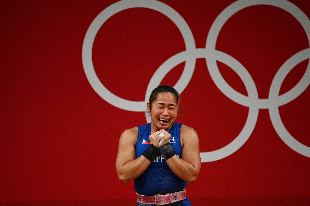 Philippines' Hidilyn Diaz reacts after placing first in the women's 55kg weightlifting competition during the Tokyo 2020 Olympic Games at the Tokyo International Forum in Tokyo on July 26, 2021.