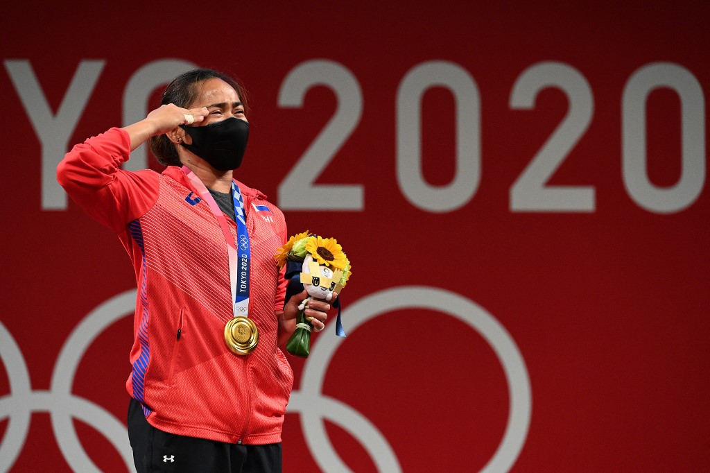 Gold medalist Hidilyn Diaz of the Philippines stands on the podium during the victory ceremony in the women's 55kg weightlifting event during the Tokyo 2020 Olympic Games at the Tokyo International Forum in Tokyo on July 26, 2021.