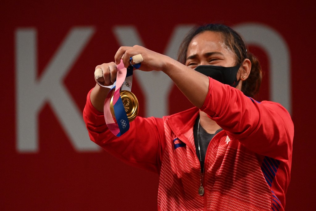 Gold medallist Philippines' Hidilyn Diaz holds her medal on the podium for the victory ceremony of the women's 55kg weightlifting competition during the Tokyo 2020 Olympic Games at the Tokyo International Forum in Tokyo on July 26, 2021.