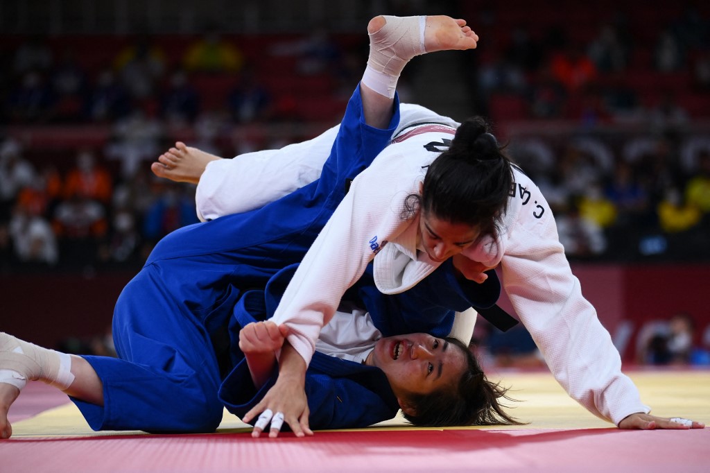 Spain's Cristina Cabana Perez (white) and Philippines' Kiyomi Watanabe compete in the judo women's -63kg elimination round bout during the Tokyo 2020 Olympic Games at the Nippon Budokan in Tokyo on July 27, 2021