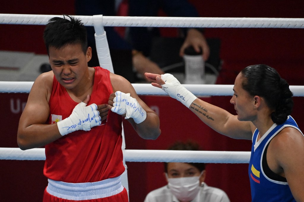 Philippines' Nesthy Petecio (red) reacts after winning against Colombia's Yeni Marcela Arias Castaneda at the end of their women's feather (54-57kg) quarter-final boxing match during the Tokyo 2020 Olympic Games at the Kokugikan Arena in Tokyo on July 28, 2021. (
