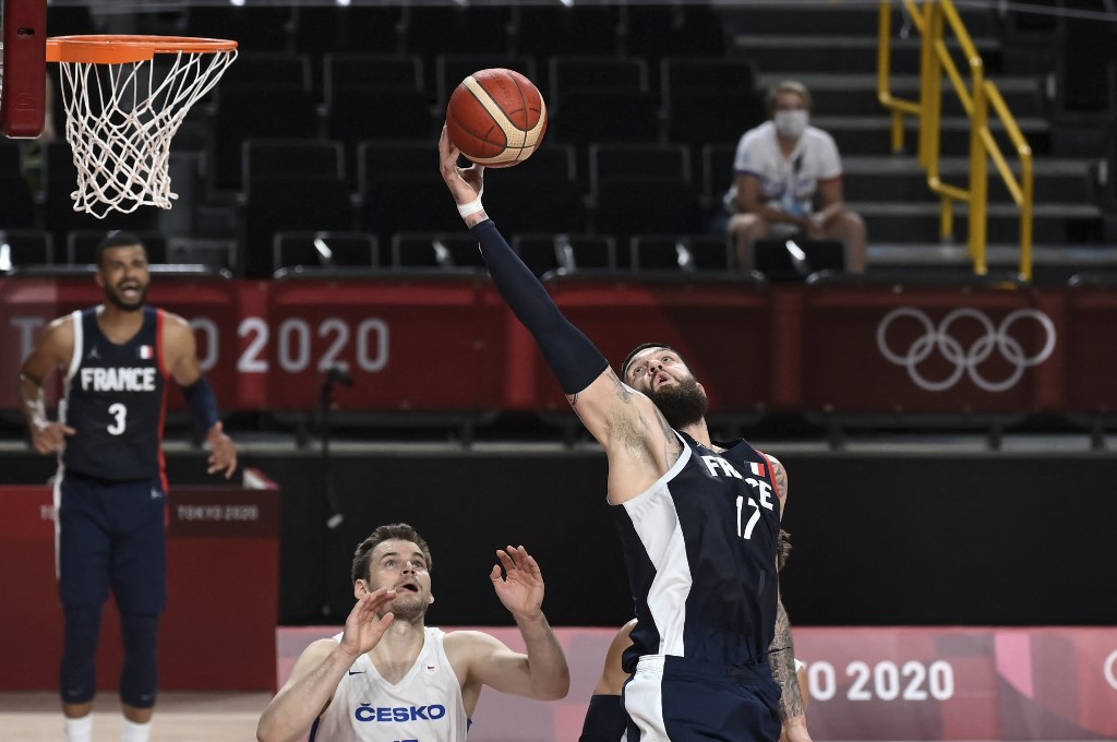 France's Vincent Poirier jumps for the ball next to Czech Republic's Jaromir Bohacik (L)  in the men's preliminary round group A basketball match between France and Czech Republic during the Tokyo 2020 Olympic Games at the Saitama Super Arena in Saitama on July 28, 2021. (