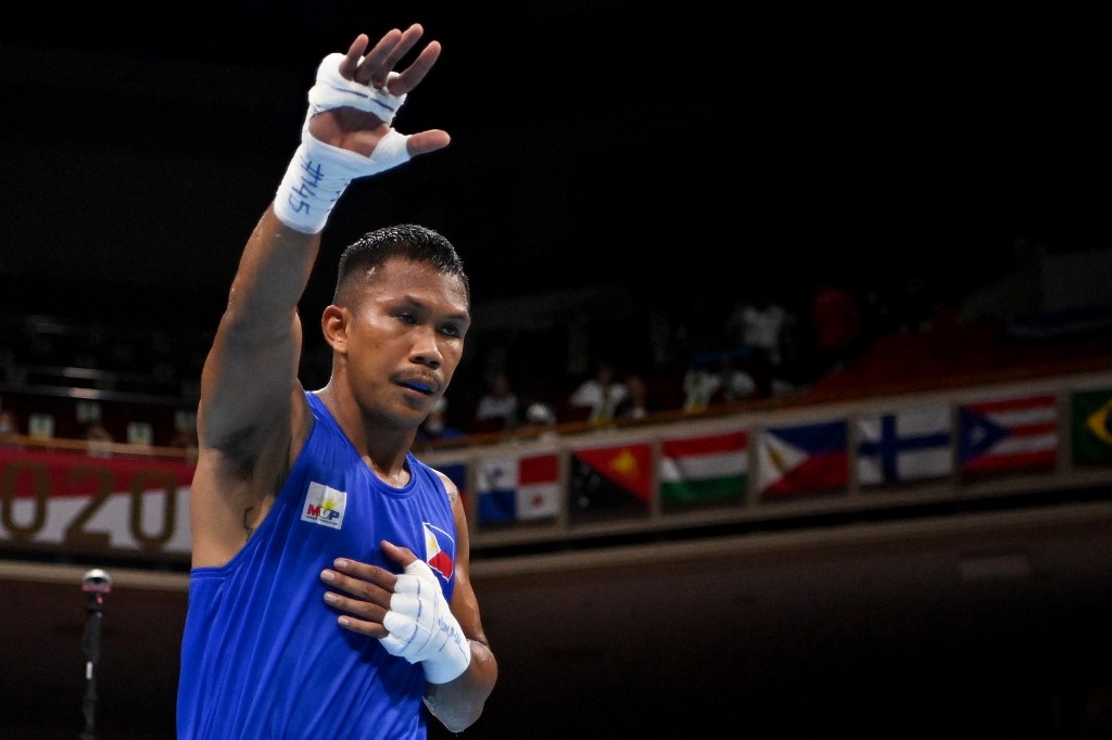 Philippines' Eumir Marcial celebrates after winning against Algeria's Younes Nemouchi (red) after their men's middle (69-75kg) preliminaries round of 16 boxing match during the Tokyo 2020 Olympic Games at the Kokugikan Arena in Tokyo on July 29, 2021. 