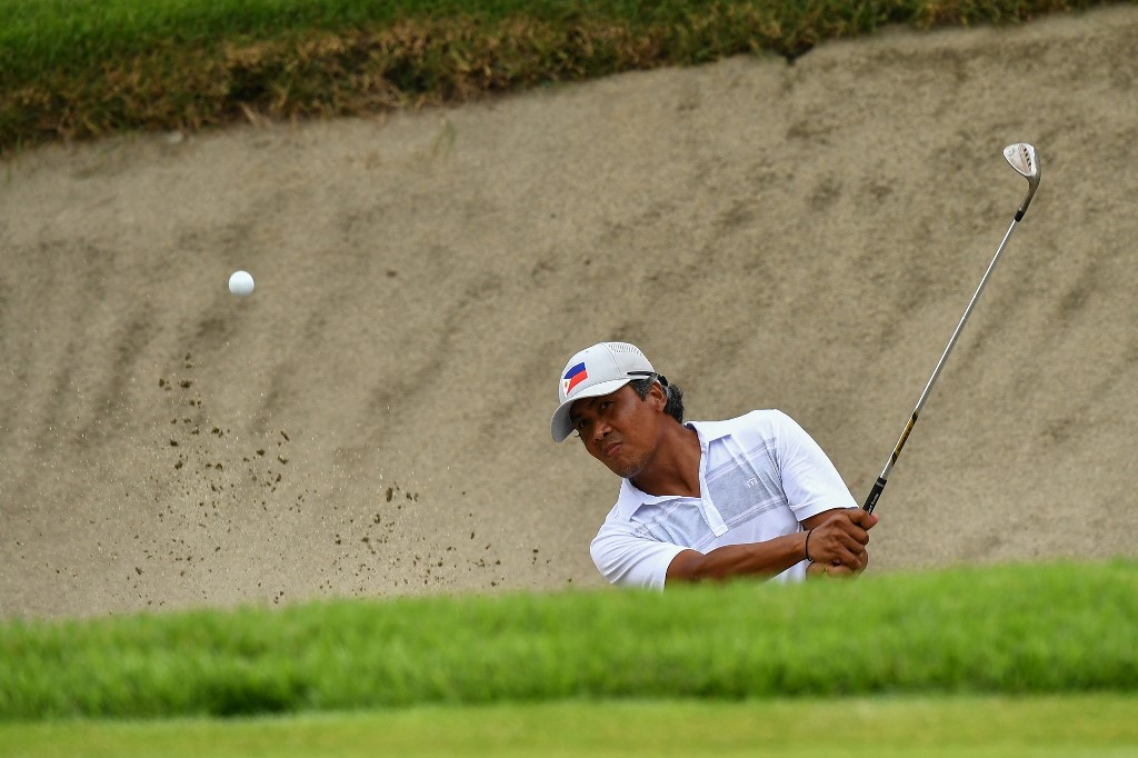 Philippines' Juvic Pagunsan plays a shot from the bunker on the 18th hole in round 2 of the mens golf individual stroke play during the Tokyo 2020 Olympic Games at the Kasumigaseki Country Club in Kawagoe on July 30, 2021.