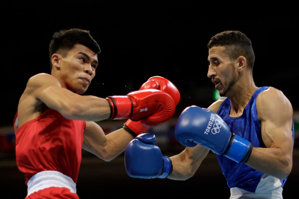 Philippines' Carlo Paalam (red) and Algeria's Mohamed Flissi fight during their men's fly (48-52kg) preliminaries round of 16 boxing match during the Tokyo 2020 Olympic Games at the Kokugikan Arena in Tokyo on July 31, 2021.