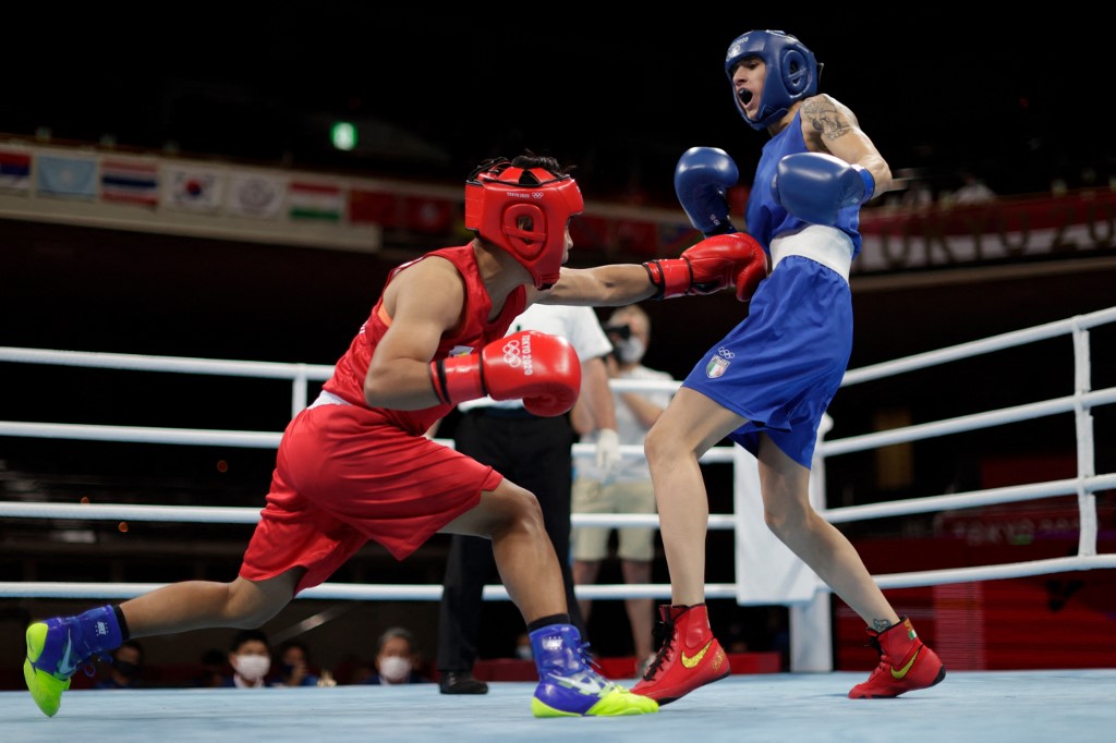 Philippines' Nesthy Petecio (red) and Italy's Irma Testa fight during their women's feather (54-57kg) semi-final boxing match during the Tokyo 2020 Olympic Games at the Kokugikan Arena in Tokyo on July 31, 2021.