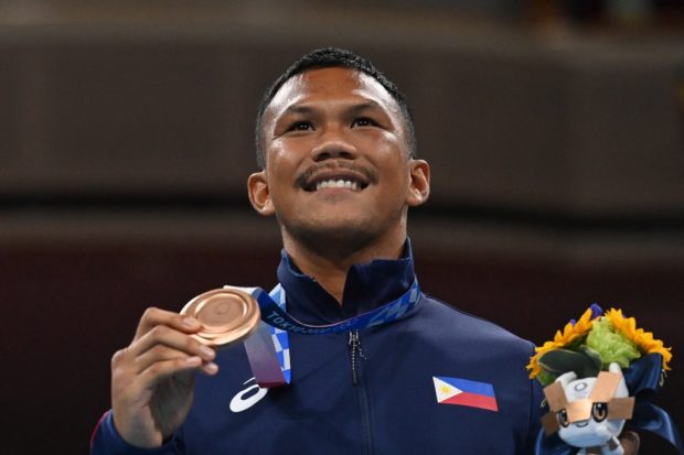 Bronze medalist Philippines' Eumir Marcial celebrates on the podium during the medal ceremony for the men's middle (69-75kg) boxing final bout during the Tokyo 2020 Olympic Games at the Kokugikan Arena in Tokyo on August 7, 2021.