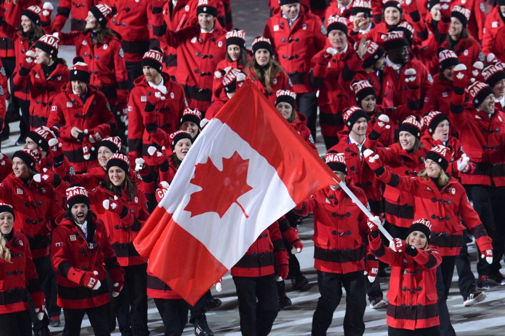 Canada's flag bearer, ice hockey player Hayley Wickenheiser leads her national delegation during the Opening Ceremony of the Sochi Winter Olympics at the Fisht Olympic Stadium on February 7, 2014 in Sochi. AFP PHOTO / JONATHAN NACKSTRAND (Photo by JONATHAN NACKSTRAND / AFP)