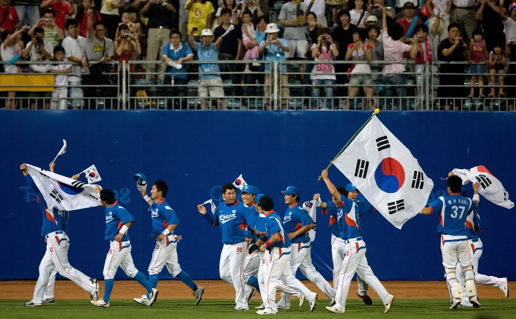 South Korean players do a victory lap for their supporters as the team celebrates their gold medal win at the end of the men's baseball final against Cuba at the Wukesong Baseball Venue during the 2008 Beijing Olympic Games on August 23, 2008