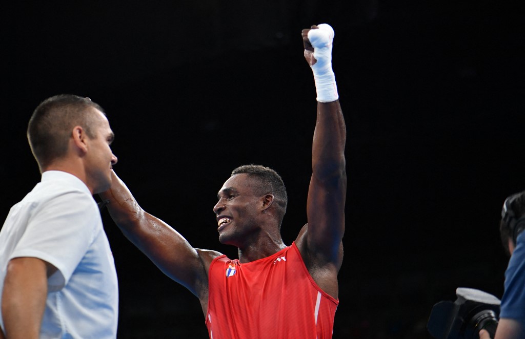 Cuba's Julio Cesar La Cruz (red) celebrates winning against Kazakhstan's Adilbek Niyazymbetov (blue) during the Men's Light Heavy (81kg) Final Bout match at the Rio 2016 Olympic Games at the Riocentro - 