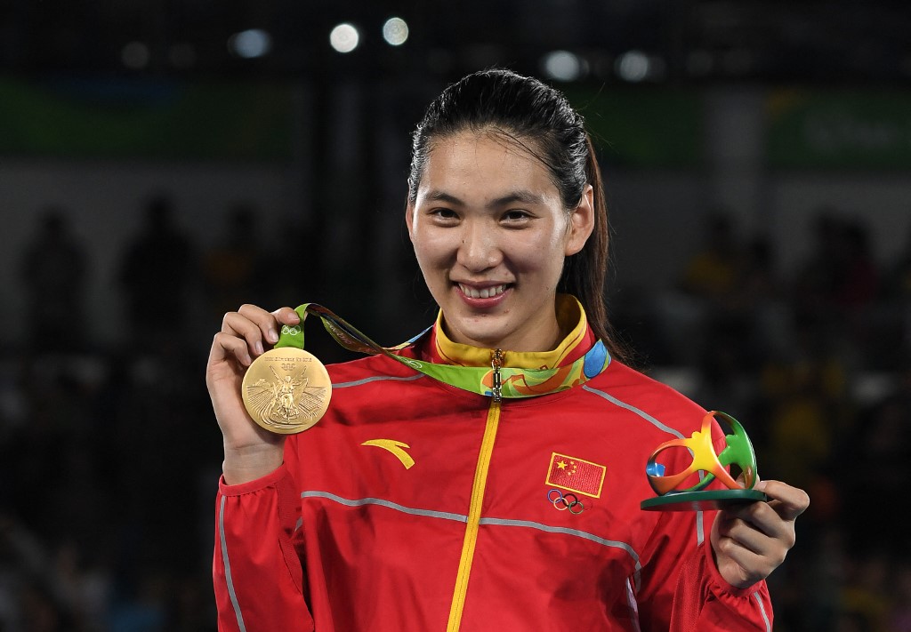 China's Zheng Shuyin poses with her gold medal on the podium after the womens taekwondo event in the +67kg category as part of the Rio 2016 Olympic Games, on August 20, 2016
