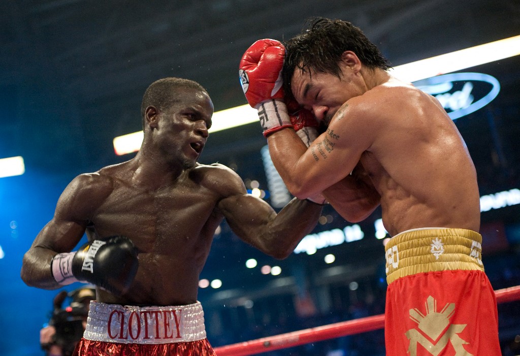 Manny Pacquiao from the Philippines (R) defends against the punches of Joshua Clottey of Ghana (L) during their World Boxing Organization (WBO) welterweight title fight at the Dallas Cowboys Stadium in Dallas, Texas on March 13, 2010